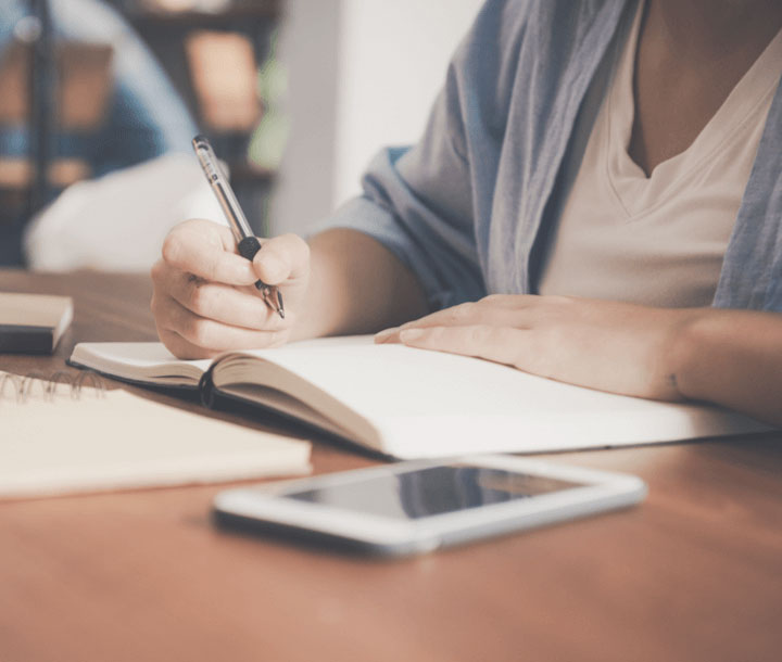 Woman writing in a book