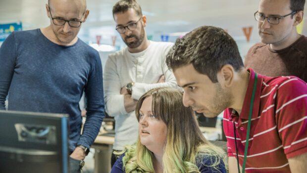 The worldwide publishing team working around a computer