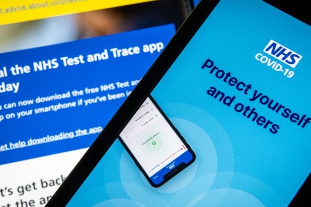 Phone with screen showing NHS and text saying protect yourself and others