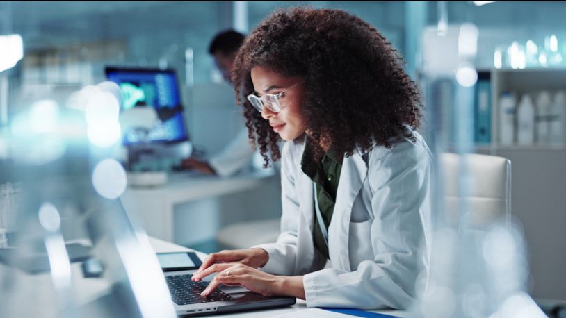 Female scientist on laptop in lab