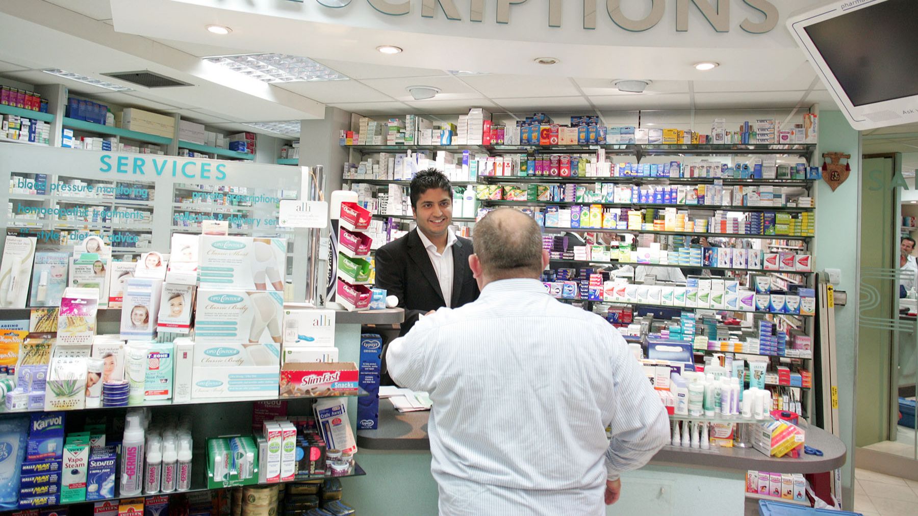 Patient at pharmacist picking up prescription
