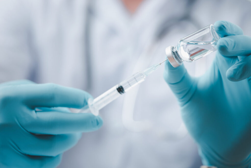 Scientist holding a vaccine.