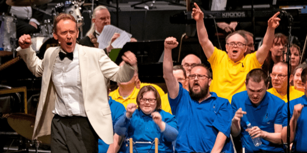 David Stanley and chorus on stage