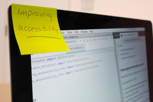 Close of yellow post it, with 'Improving Accessibility' written on it ,stuck to a laptop screen
