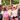 People dancing in an open field at a festival 