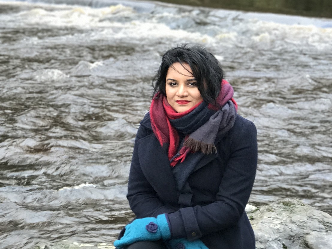 Woman in a scarf by a river