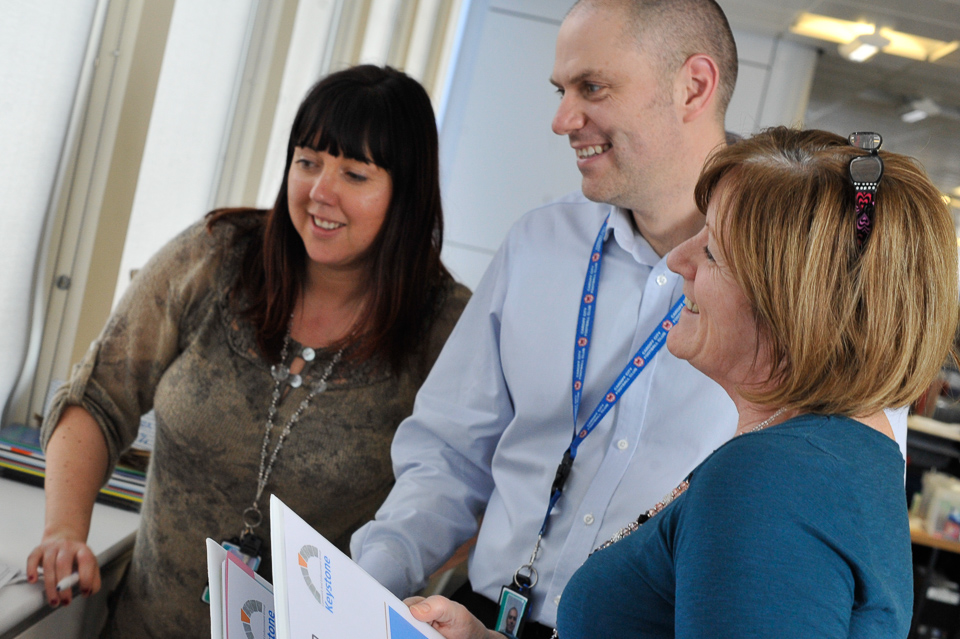 DfT HR team of two women and one man, smiling at DVLA.