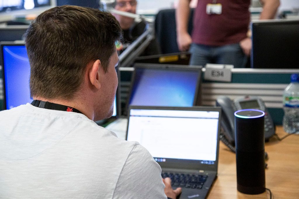 Male DfT Digital professional using a laptop.