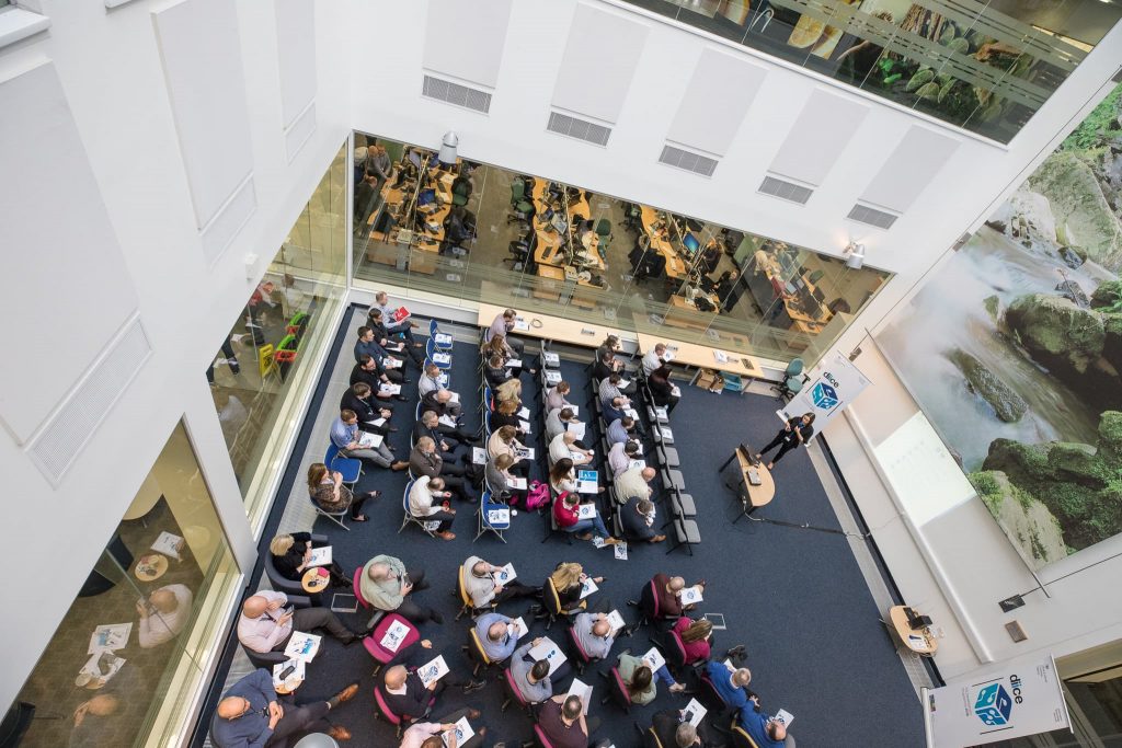 Audience listening to a speaker at a learning and development event.