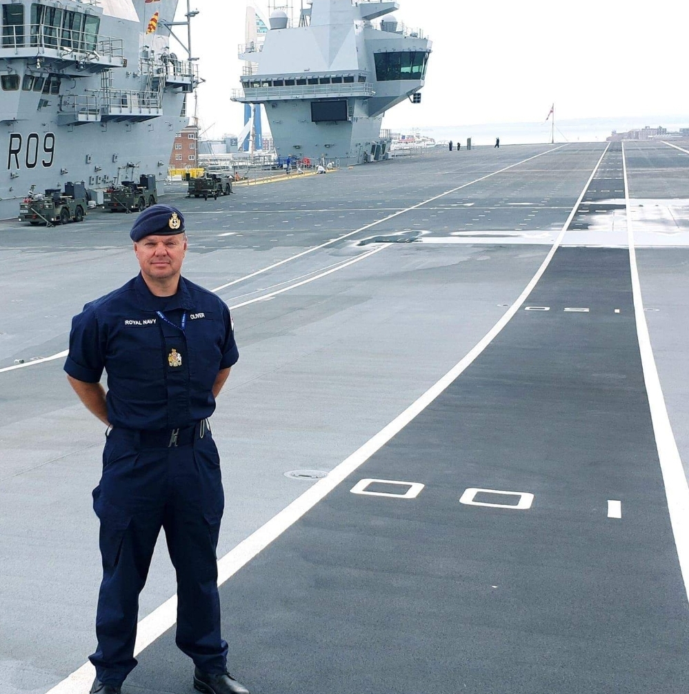 Jon Oliver on the flight deck of a Royal Navy vessel