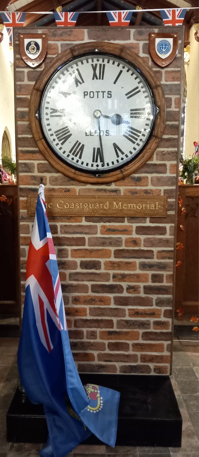 The memorial clock draped with an HM Coastguard flag at St Nichloas Withernsea