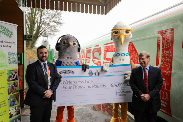 Tom Desmond and Stephen Evans shake hands after the presentation of a £4,000 cheque to The Watercress Line