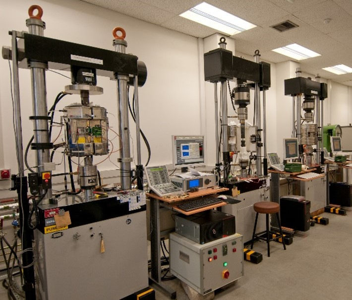 Photo shows a row of three servo-hydraulic material testing rigs inside Siemens Energy's laboratories.