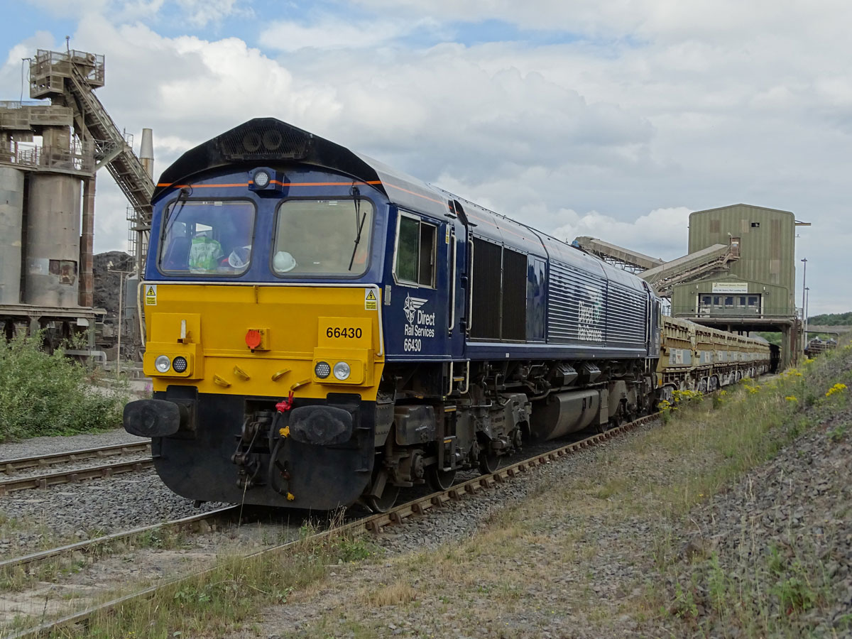 Train with backdrop of factory