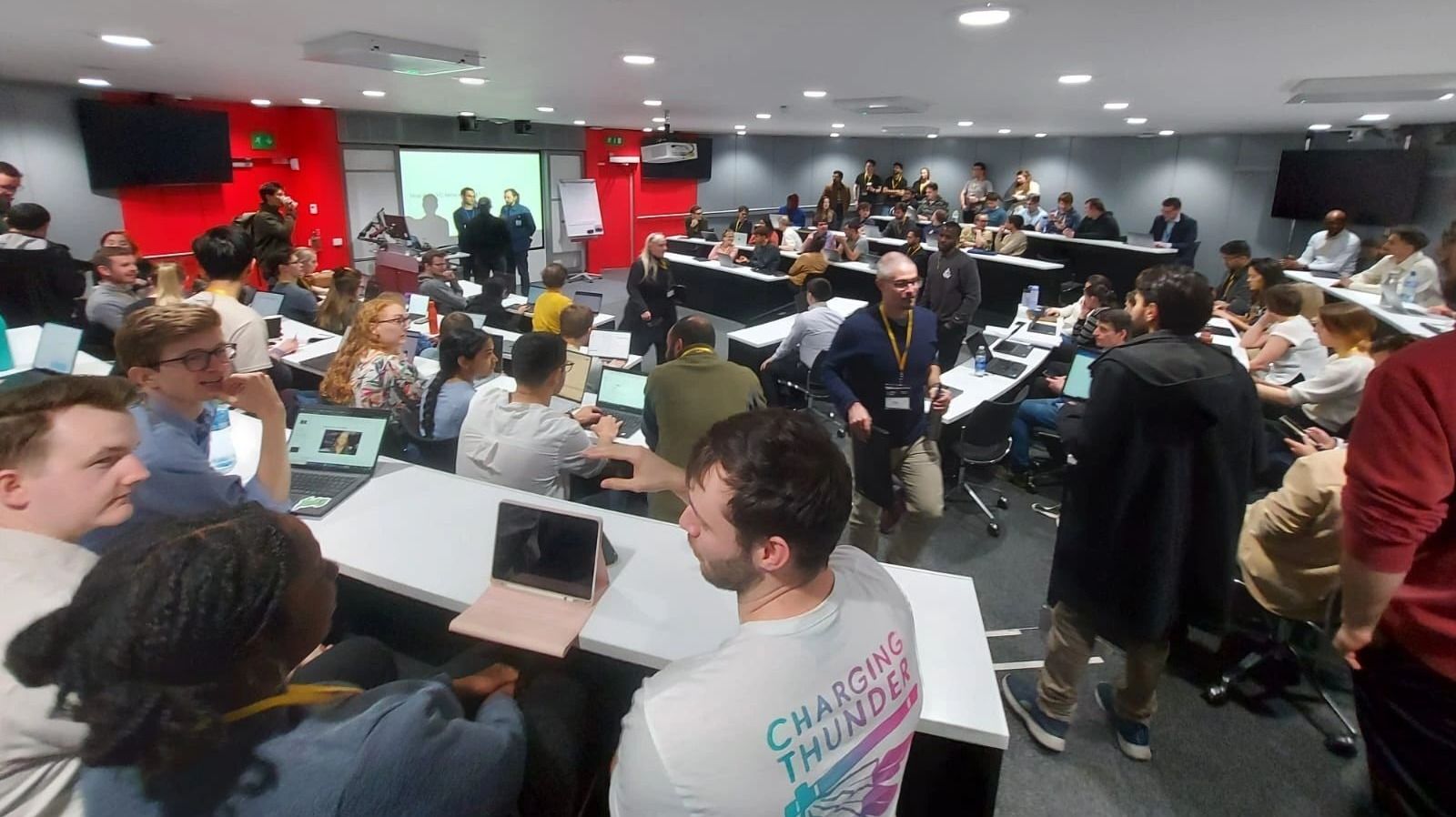 People sat at rows of desks working together