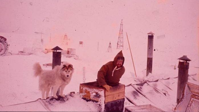 A man standing next to a dog