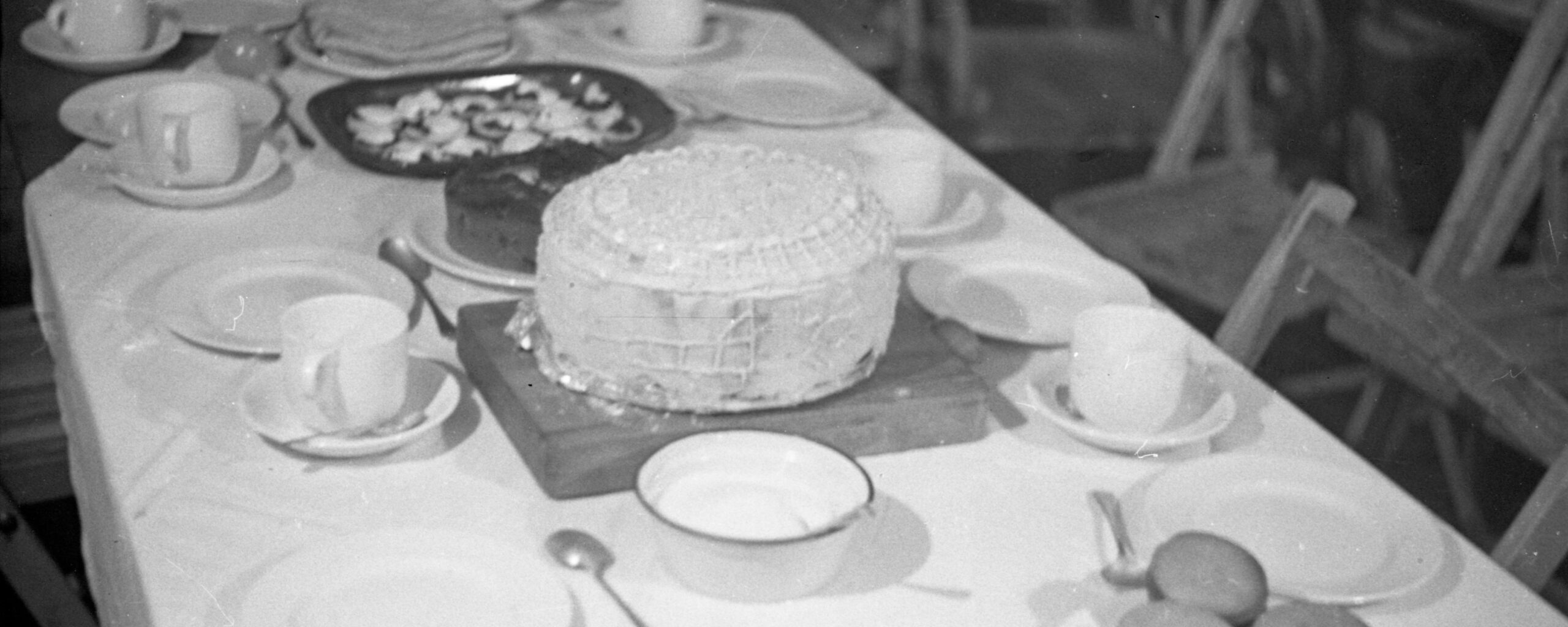 A dining table with a cake on a plate