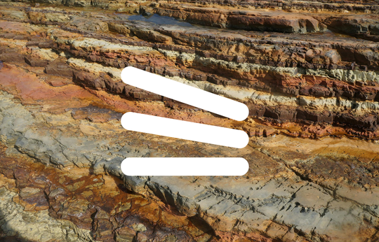 Stacks or layers icon in front of an image of geological terrain