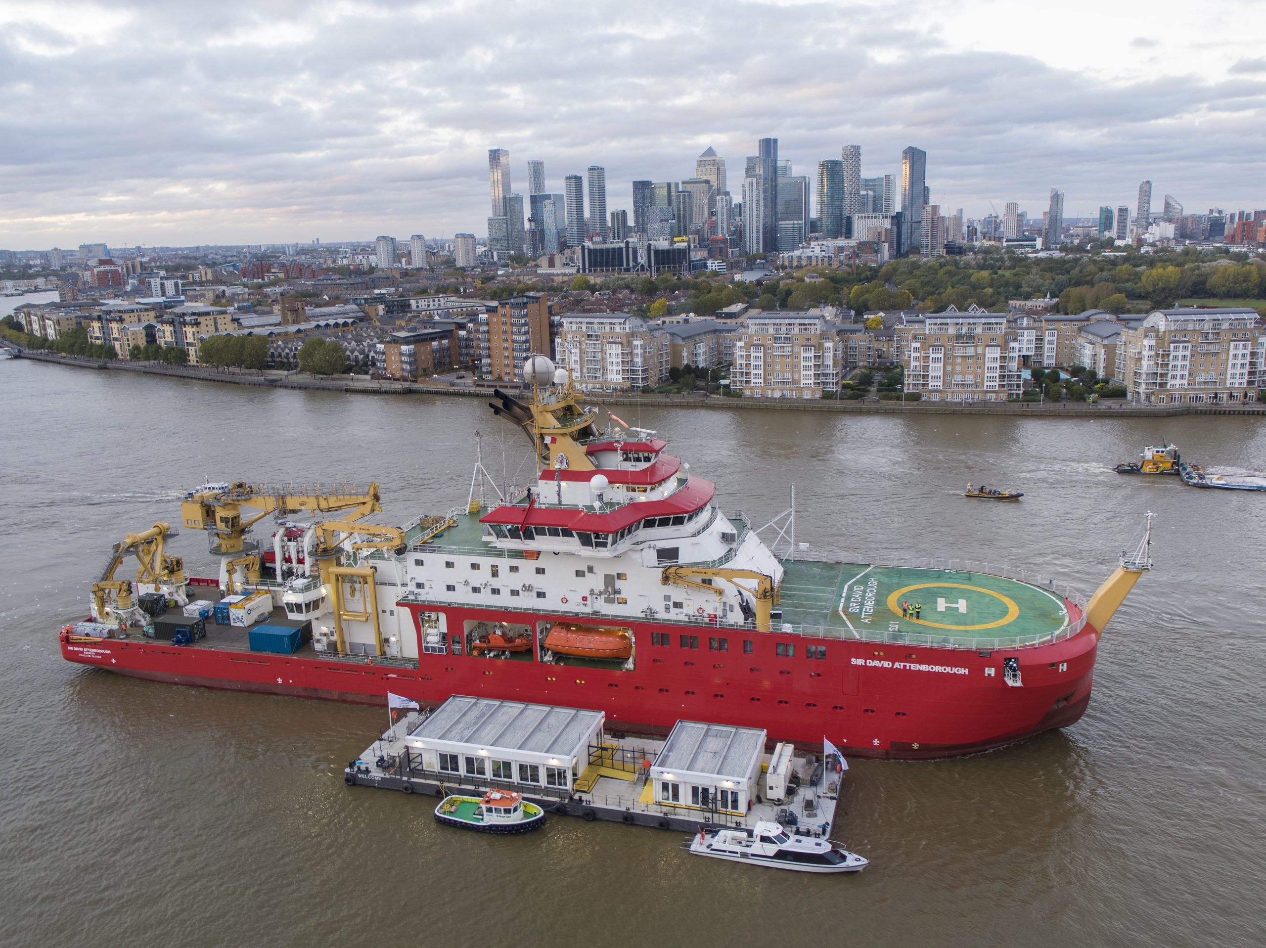 A large red ship in a river.