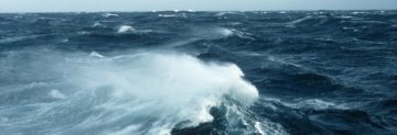A man riding a wave in the ocean.
