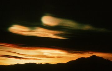 Nacreous (also known as mother of pearl or stratospheric) clouds. These clouds form at around 20km altitude in the ozone layer and are instrumental in the process of ozone depletion. Because of their altitude they remain illuminated by the sun, long after sunset on the ground.