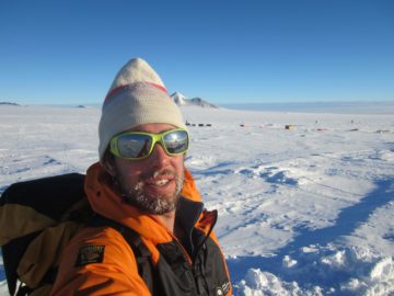 A man that is standing in the snow.