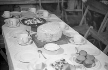 A dining table with a cake on a plate