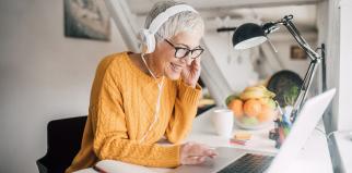 Smiling lady working at laptop