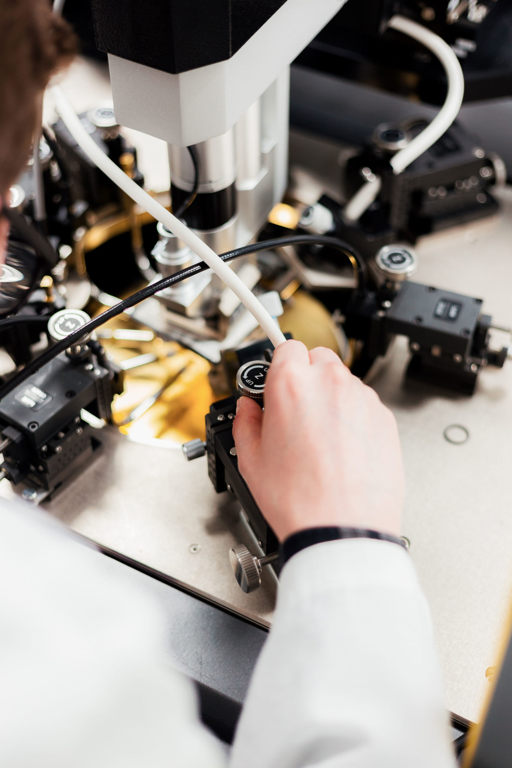 A person adjusts laboratory equipment with precision, possibly working on a scientific experiment or research. - CSA Catapult