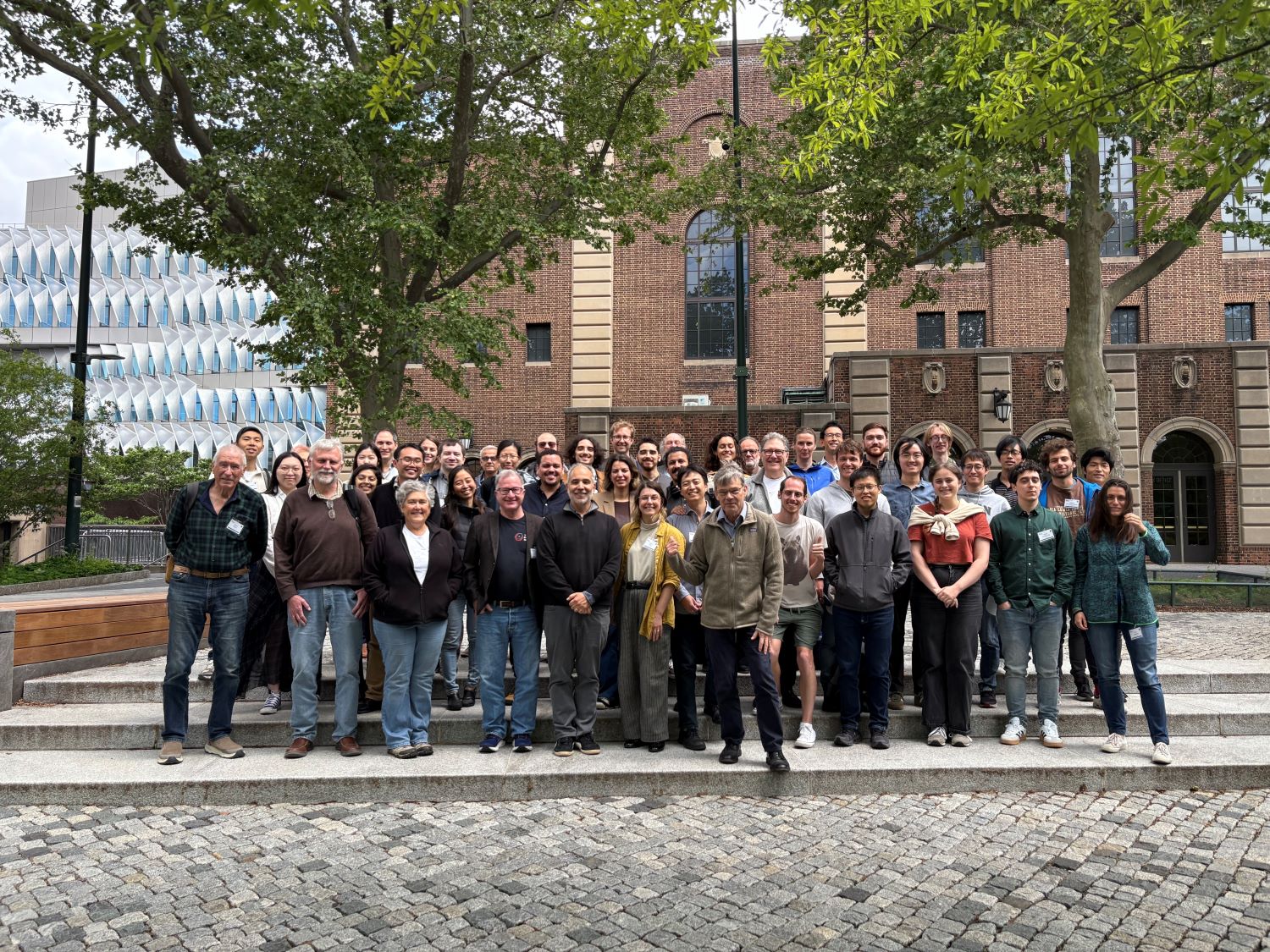 a group of people smiling for a photo outside a building