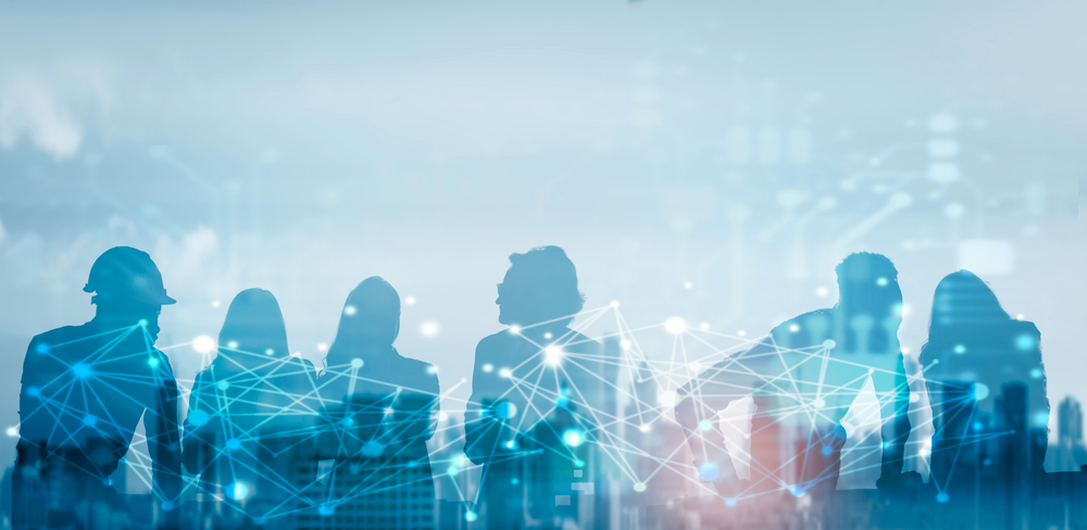 Silhouettes of people with abstract blue digital connections overlaid on a cityscape background.
