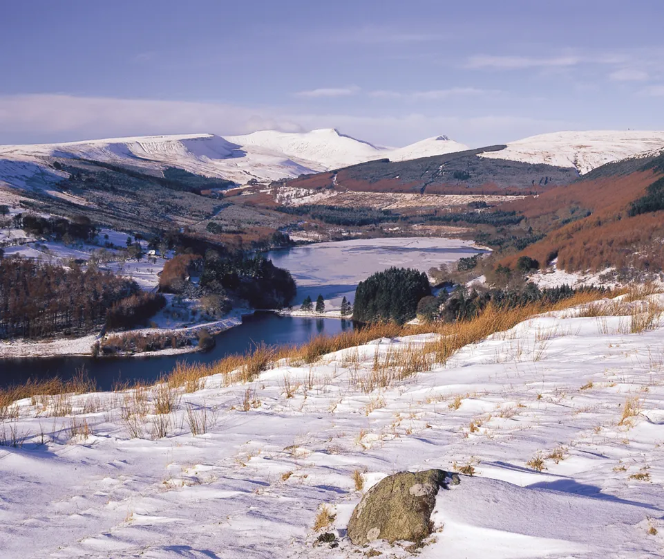 Snow covered mountains and fields on a bright sunny day