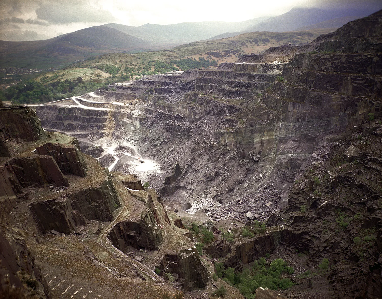 A slate quarry showed stepped terraces down to the quarry bottom
