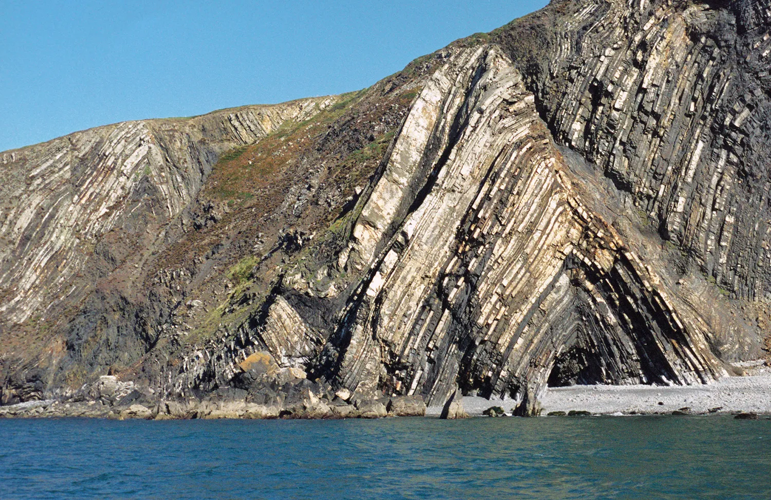 Layers of rock folded into an upside-down V-shaped anticline