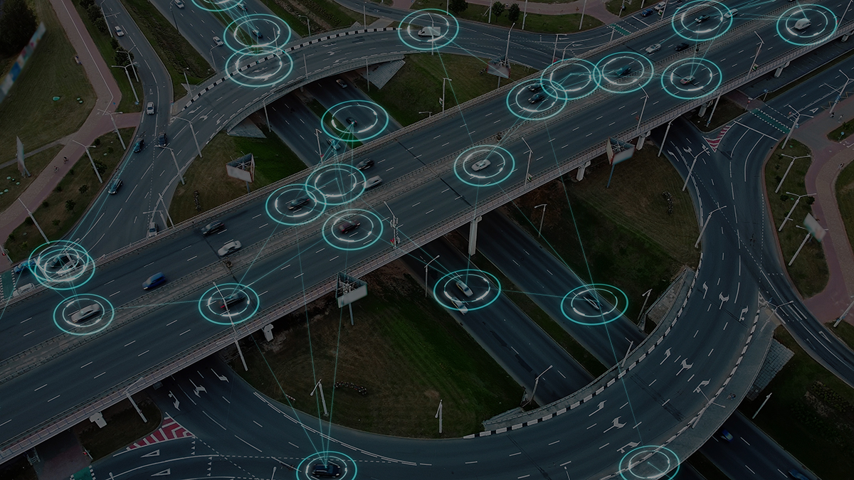 Aerial view of a highway with multiple vehicles, overlaid with digital connectivity symbols.