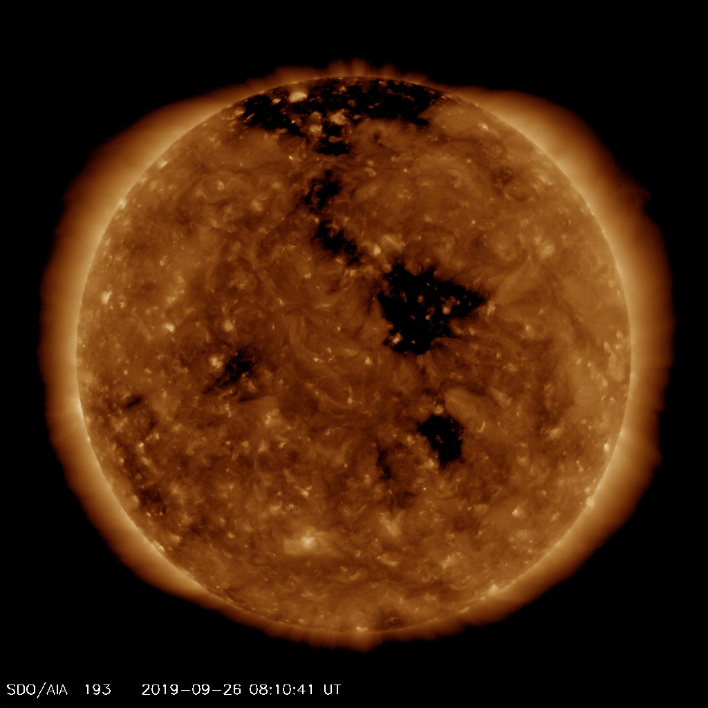 EUV image from SDO satellite showing centrally located coronal hole (black area). Image from SDO (NASA).