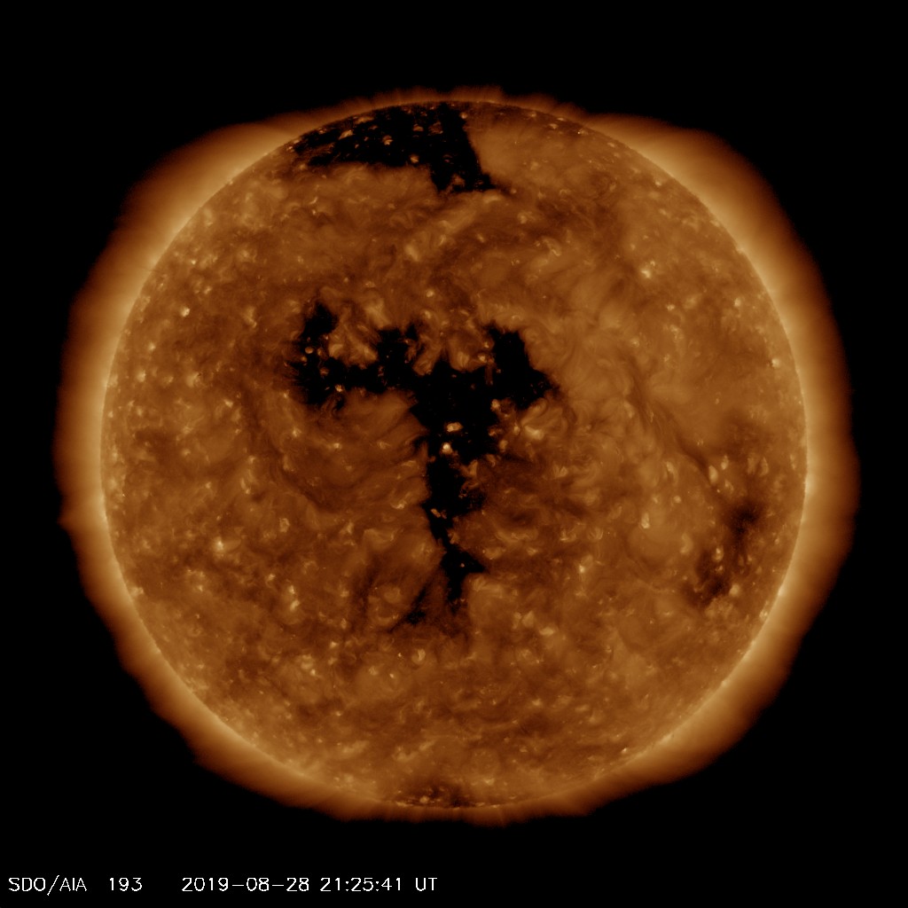 EUV image from SDO satellite showing centrally located coronal hole (black area). Image from SDO (NASA).