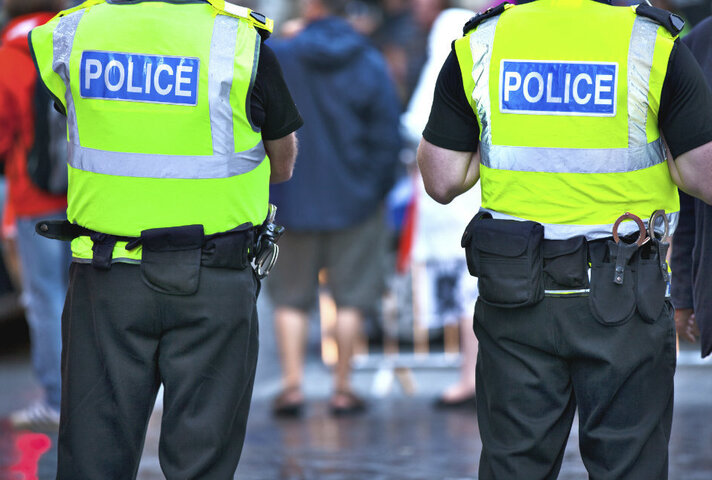 Two police officers from behind.