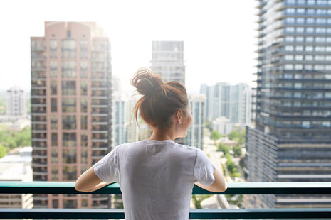 A resident on a balcony of a building that has gone through the building control process