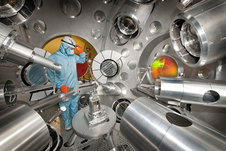 A person wearing PPE working at the Orion Laser Facility