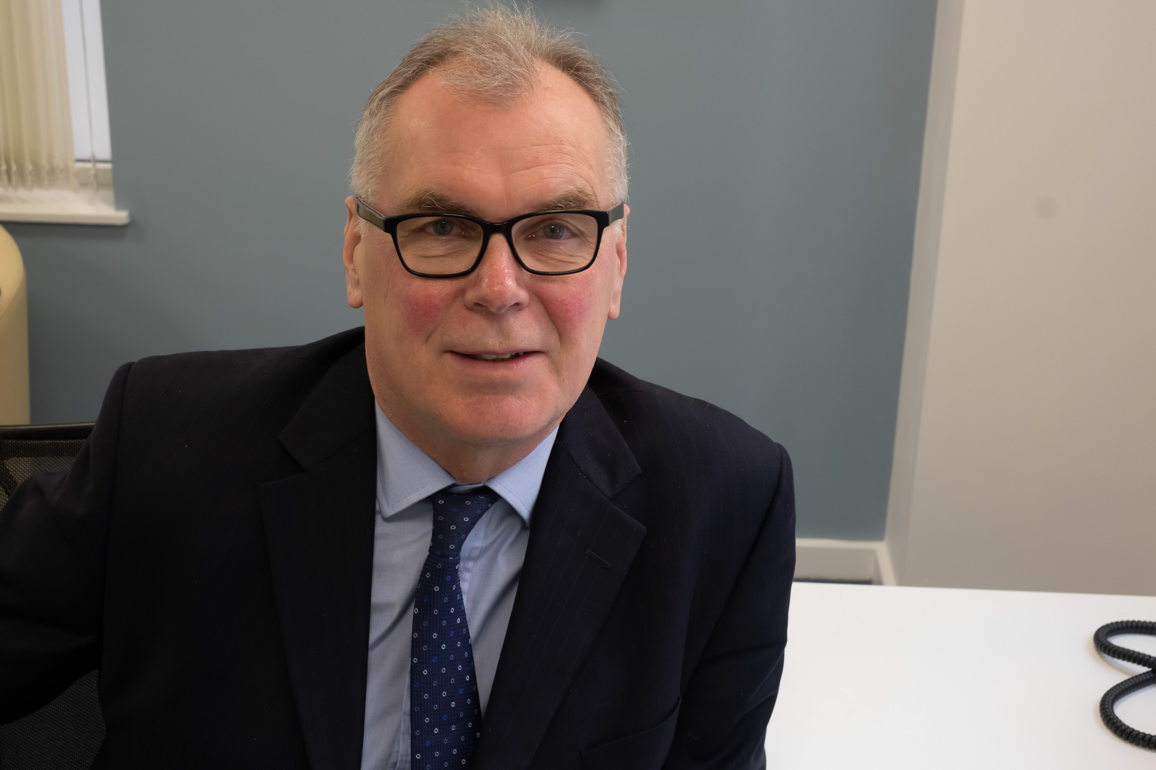 Government Actuary Martin Clarke, seated facing the camera