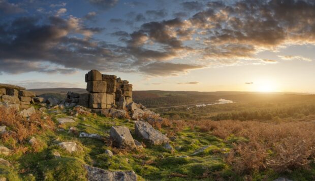 A view across Dartmoor with a large rocky formation in the foreground