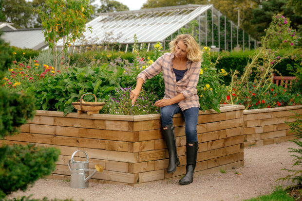 Woman sat on WoodBlox raised bed