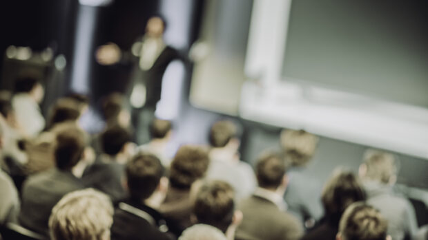 An audience sitting in a conference.