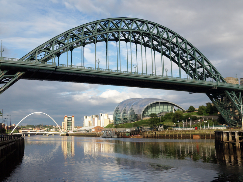 A view of the Tyne Bridge in Newcastle, with the Gateshead Millennium bridge and the Sage Centre in the background.