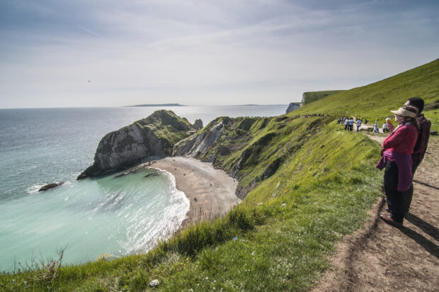 Tourist enjoying beautiful scenery at the Jurassic Coast, Dorset, Tourist enjoying beautiful scenery at the Jurassic Coast, Dorset,