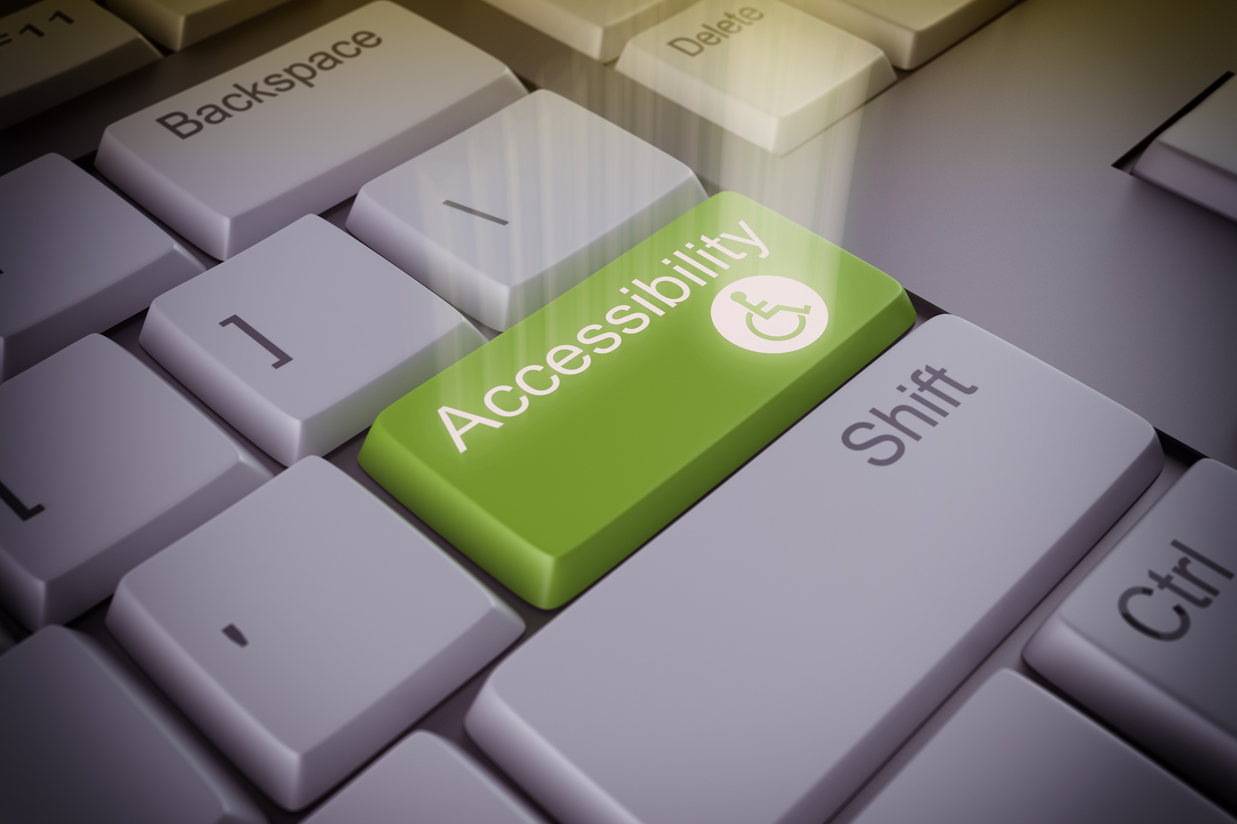 Computer keyboard with an accessibility green key.