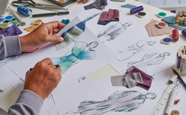 An image of a fashion designer designing clothes