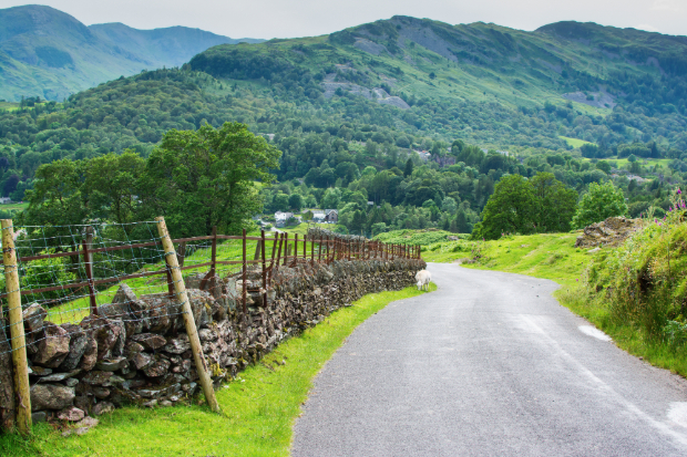 Photo showing a country road with hills in the background