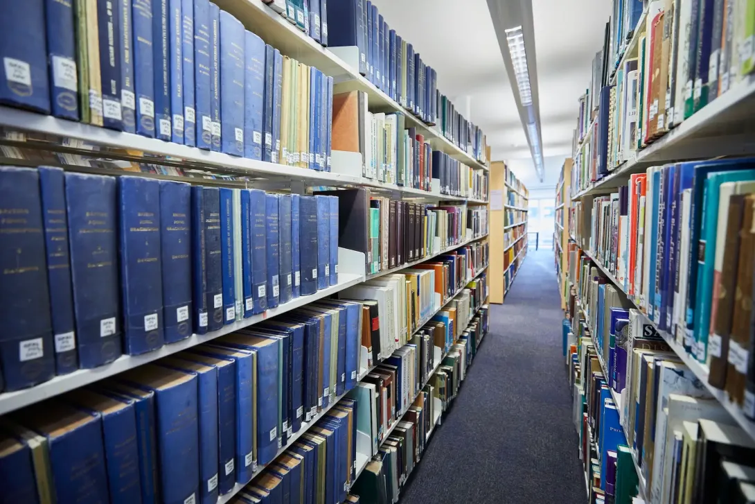 Long book shelves featuring books relating to marine and earth science